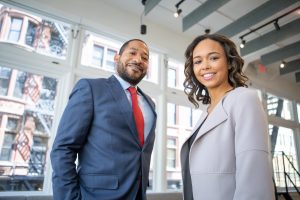 businessman and businesswoman standing and smiling